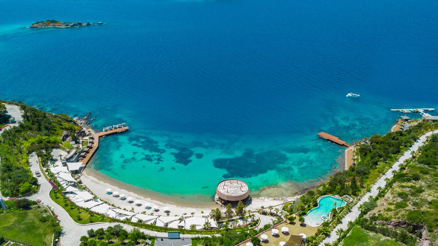 The secluded bay and its 650 m sandy beach